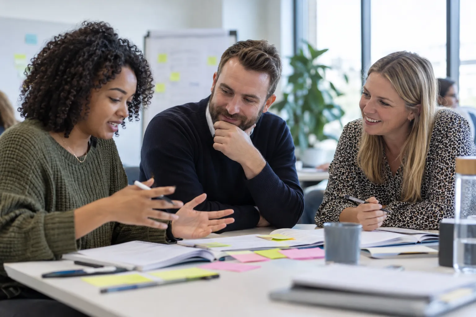 Three delegates working through a group exercise
