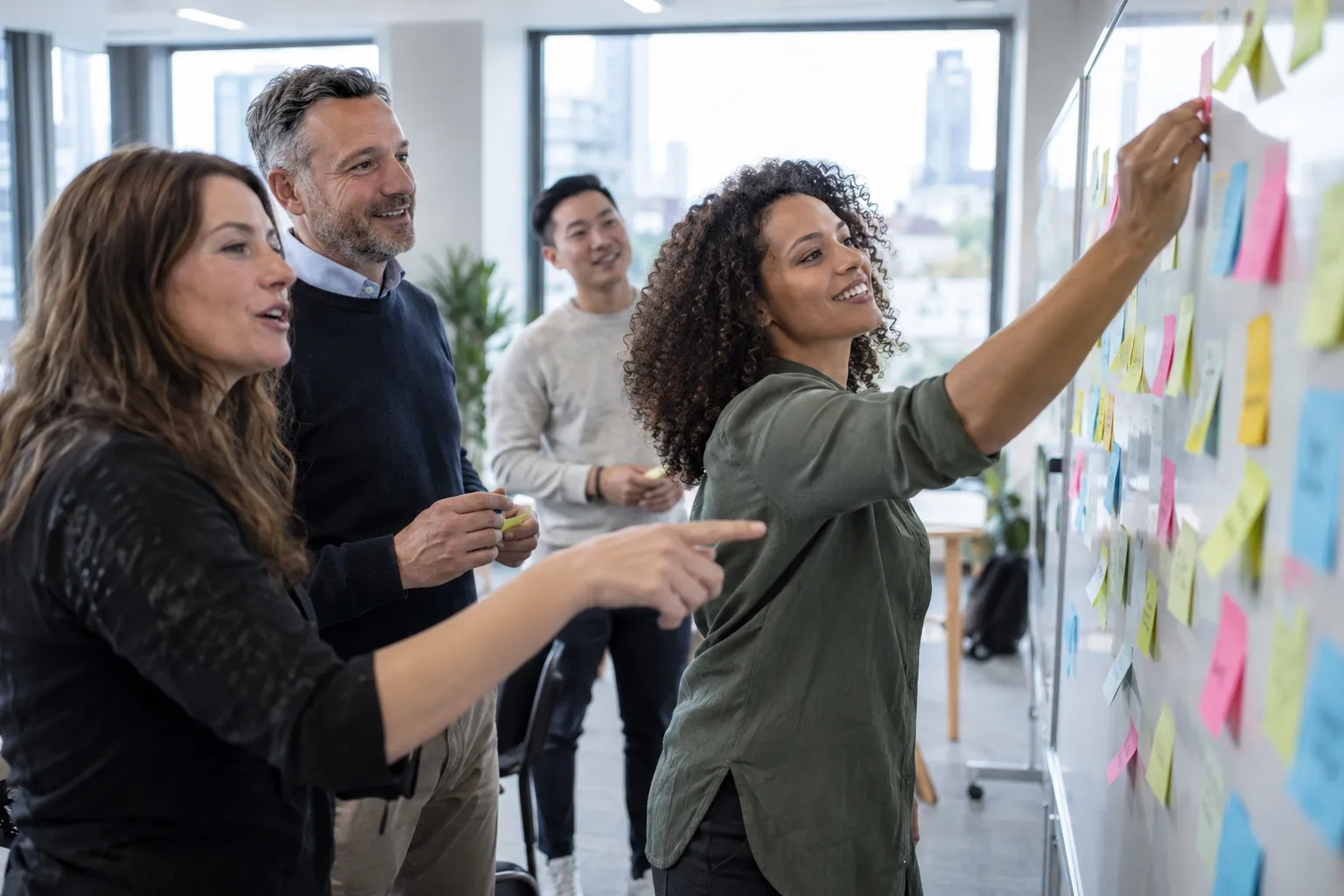 Delegates sorting ideas on a whiteboard during an exercise